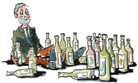 Man sitting depressed between a lot of bottles